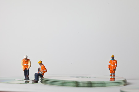 Miniature people in action in various situationsの写真素材