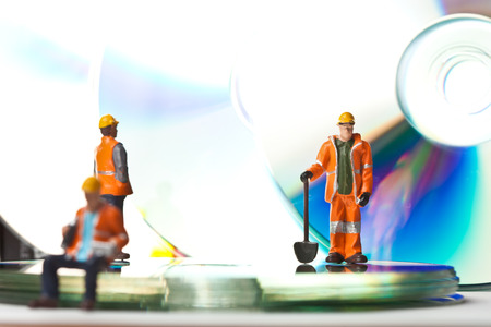 Miniature people in action in various situationsの写真素材