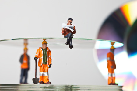 Miniature people in action in various situationsの写真素材