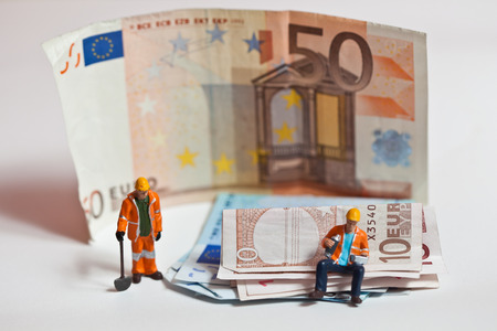 Miniature people in action in various situationsの写真素材