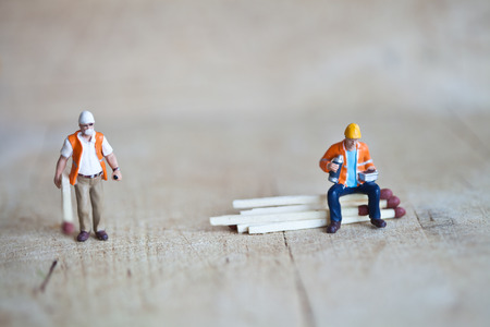 Miniature people in action in various situationsの写真素材