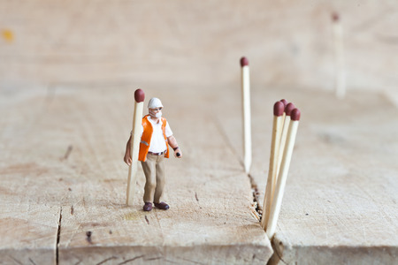 Miniature people in action in various situationsの写真素材
