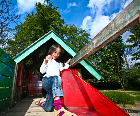 Girl on a playfield in Denmark in the sunの写真素材