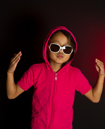 girl with sunglassesplaying smart in redの写真素材