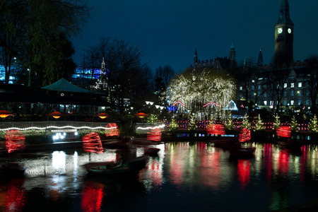 Christmas at the Tivoli in Copenhagen at night. Illuminations on the lake tower in the backgroundのeditorial素材