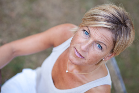 Cute woman reading a book outdoorの写真素材