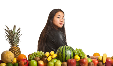 Many fruits stacked together and cute girlの写真素材