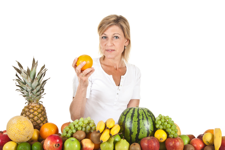 Many fruits stacked together and cute womanの写真素材