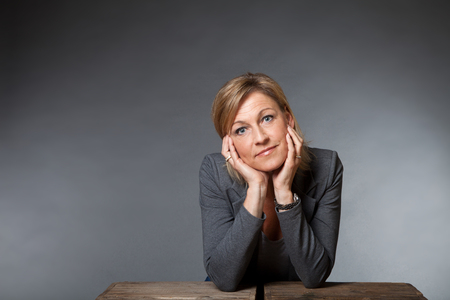 Cute woman portrait with grey backgroundの写真素材