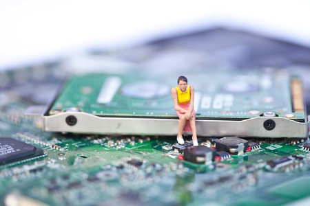 Macro picture of computer electronics with people sittingの写真素材