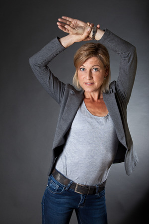 Cute woman portrait with grey backgroundの写真素材