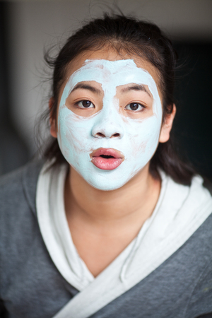 Young cute girl with a self made beauty maskの写真素材
