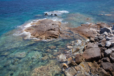 Rocks at the beach in Algajola Village or town in  Corsica in the Balagne arean the summerの写真素材