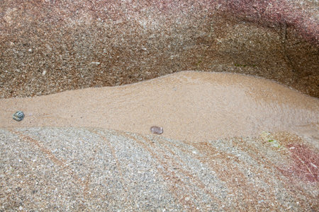Rocks at the beach in Algajola Village or town in  Corsica in the Balagne area in the summerの写真素材