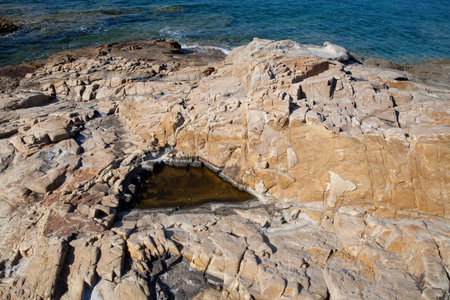 Rocks at the beach in Algajola Village or town in  Corsica in the Balagne arean the summerの写真素材