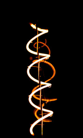 glowing energy light bulb in the darkの写真素材