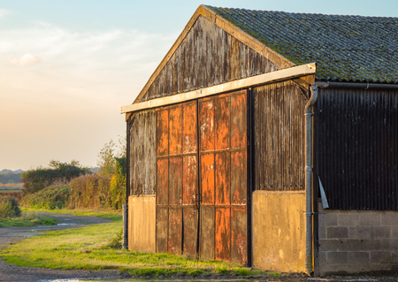 Barn is on farmland near the village of Abridge in Essex, England on a bright autumn day.の写真素材