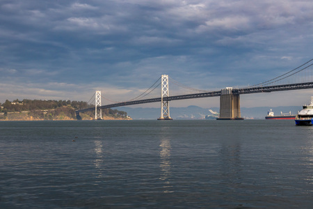 Bay Bridge in San Francisco, California, taken in winter with a stormy sky.の写真素材