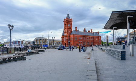 Cardiff Bay, Cardiff, Wales - May 20, 2017: Sinedd, National Assembly building and Pierhead builidng.  Shows wide walkway with people.のeditorial素材