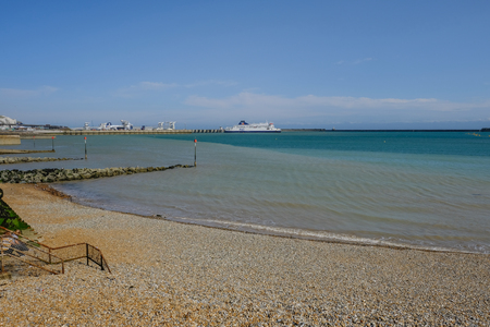 Dover, Kent, UK - August 17, 2017:Dover beach and harbour with Ferry departing. Summer shot from the beach.のeditorial素材