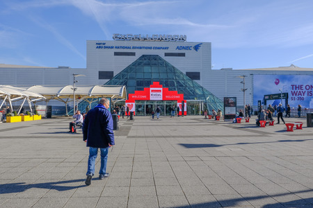 London, UK - February 16, 2018: Rear view of man walking towards the entrace of Excel Exhibition Centre at Royal Docks, London.のeditorial素材