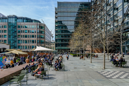 Exchange Square, Liverpool Street, London, UK - April 6, 2018: Lunch time on a sunny day with office workers enjoying the sunshine.のeditorial素材