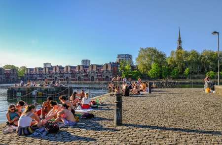 Shadwell Basin, London, UK - May 7, 2018: Young people enjoying the sunshine and sunbathing on the quay side of Shadwell Basin.のeditorial素材