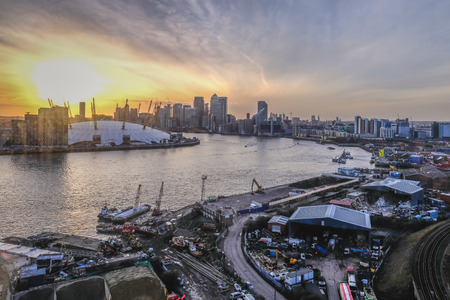 Roya Victoria Dock, London, uk - February 14, 2018: Aeirial view from the cable car at sunset.  Shows the sun going down behind the O2 and Canary Wharf as you make the crossing.のeditorial素材