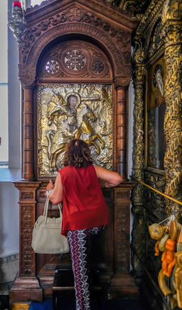 Nicosia, Cyprus - May 14, 2018: Icon for George in the Holy Mary Church in the old town of Nicosia. Shows the rear view of a lady kissing the icon with reverance.のeditorial素材