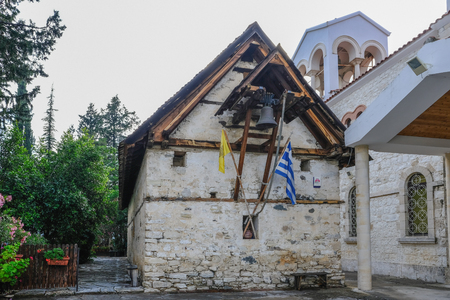 Trimiklini, Cyprus - May 13, 2018: view of the ancient church devoted to Panagia Eleousa in the centre of Trimiklini village and besdie the larger and more modern church.のeditorial素材