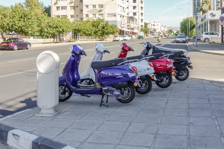 Limassol, Cyprus - April 3, 2018:  Four new Zhen scooters on display on the pavement of a busy main road. Four colours to choose from.のeditorial素材