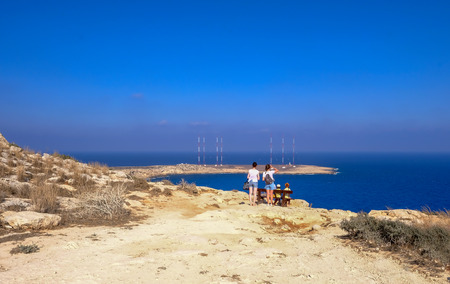 Cape Greko, Cyprus - June 25, 2018: Rear people at the viewing point looking out to sea at a magnificent view.のeditorial素材