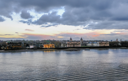 Greenwich Royal Naval College landscape, with river Thames in the foreground and beautiful sunset colours in the sky.の写真素材