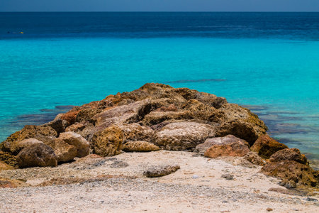 Beautiful beach with rocks and turquoise sea in the backgroundの写真素材