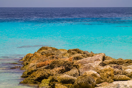 Tropical beach with rocks and turquoise water in CuraÃ§aoの写真素材