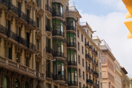 A street view showcases a mix of architectural styles in a city. The buildings feature ornate...