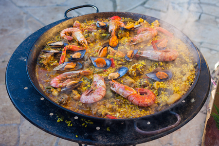 Traditional Spanish paella with seafood and chicken in a panの写真素材