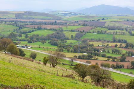 Green hills with mountains in the background. Asturias, Spainの写真素材