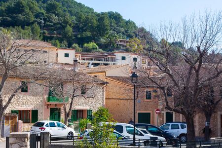Green mountain and bright houses in Esporles, Mallorca, Spain