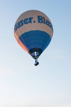 Manacor, Mallorca, Spain - October 27, 2019:  FAI European Hot Air Balloon Championship in Spain. Blue and white balloon in flightのeditorial素材