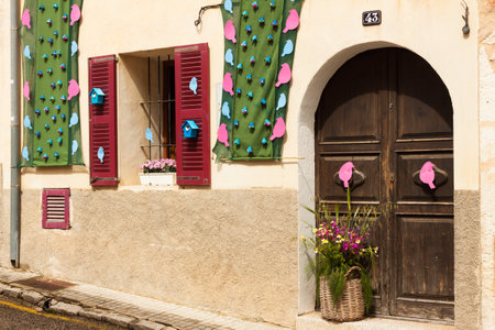 House, decorated with pink and blue birds on "Costitx en Flor" (Costitx in bloom) Flower Fair, Majorca, Spainの写真素材
