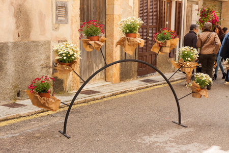 COSTITX, MAJORCA, SPAIN - MAY 1, 2018: Metallic arch with flower pots of pink and white chrysanthemums on "Costitx en Flor" (Costitx in bloom) Flower Fair, Majorca, Spainのeditorial素材