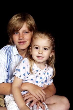 brother and sister posing for the cameraの写真素材