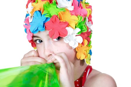  Beautiful little girls in a flowered swim cap blowing up a bright green inner tubeの写真素材