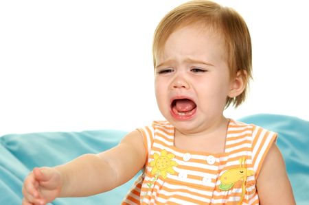 Baby Crying and reaching for something on white backgroundの写真素材