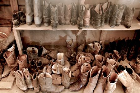 Tack Room full of  Well Worn Cowboy Bootsの写真素材