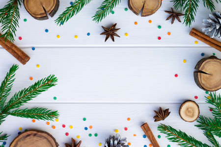 Green branches of a Christmas tree and confetti on a background of white boards. Flat lay. Copy space.の写真素材