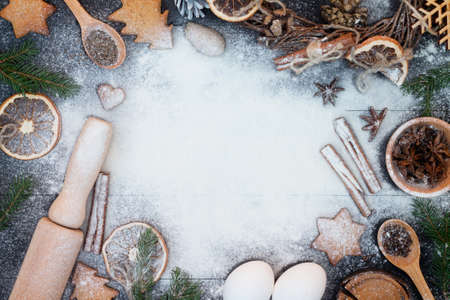 Flour New Year background. Baking supplies on black wood background. Christmas, New Year greeting cardの写真素材