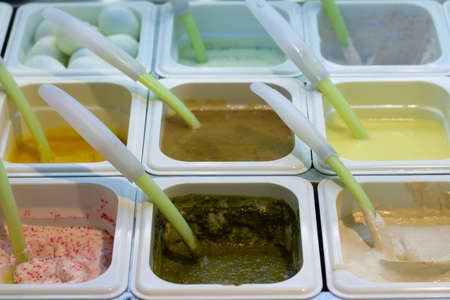 Various sauces in containers with spoons in a self-service cafe in a shopping mallの写真素材