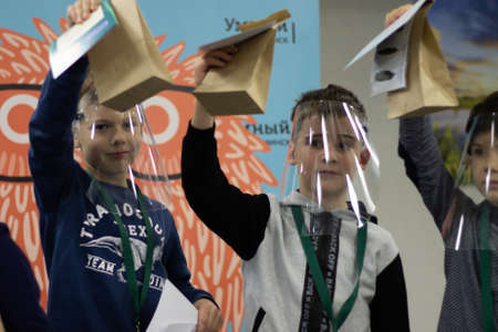 Children's science event during the coronavirus pandemic, children in protective screensのeditorial素材